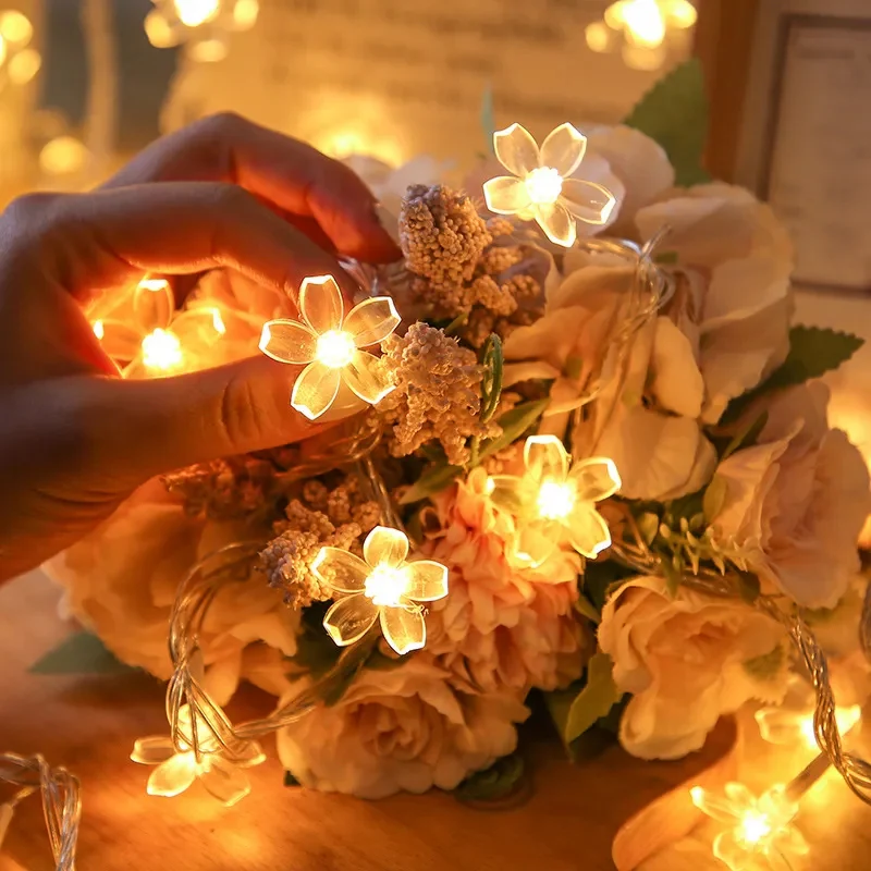 Warm glowing cherry blossom string lights with flowers